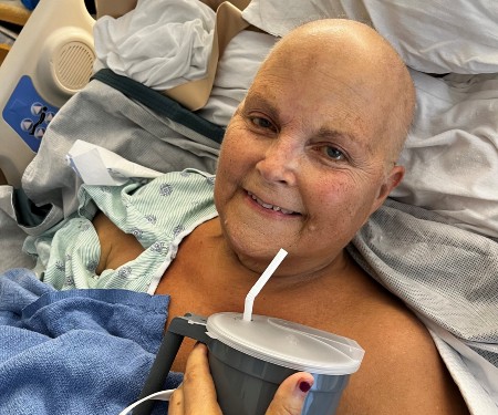 Judy Lines wearing a blue patient gown at the medical center